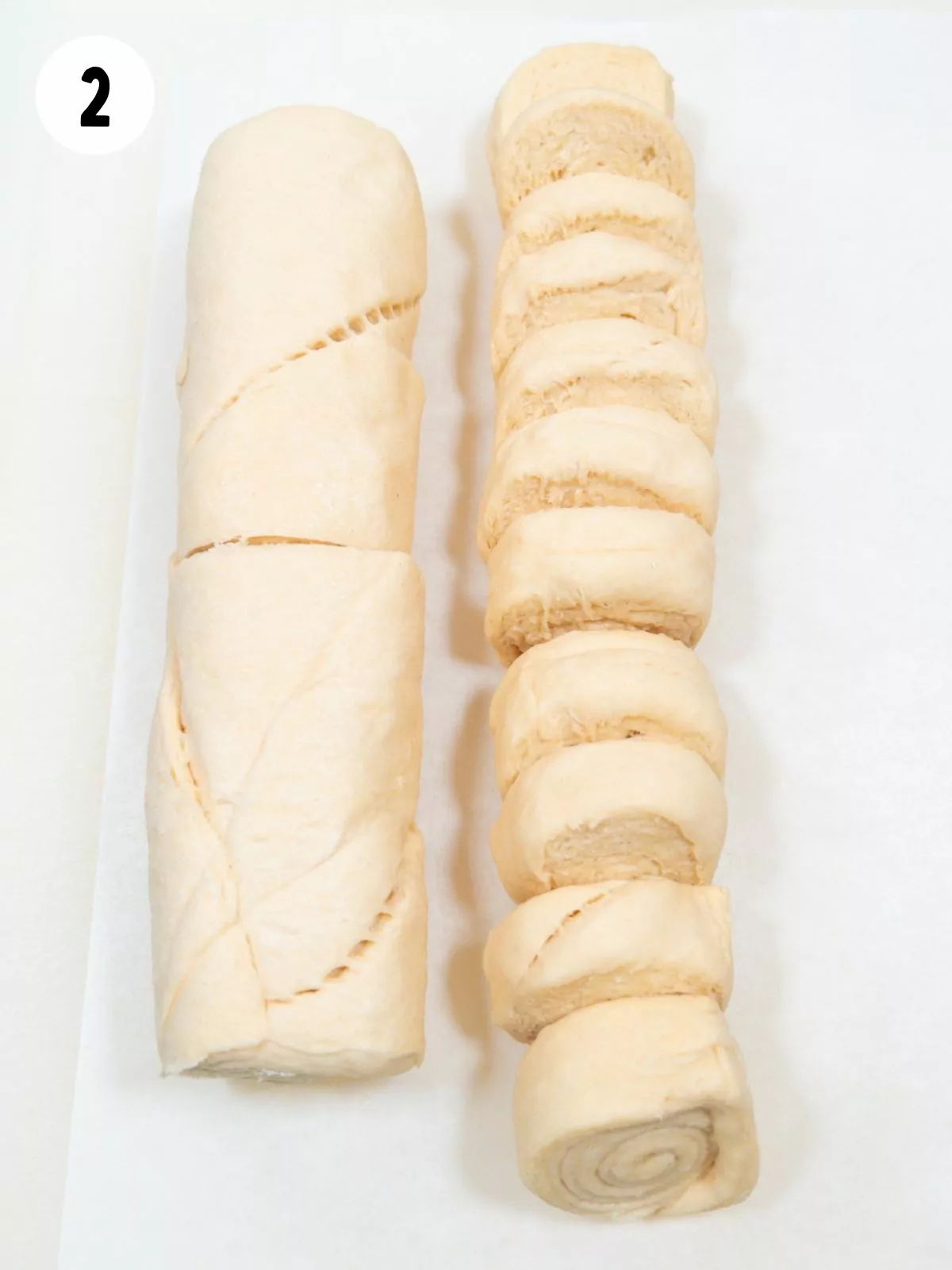 Sliced crescent roll dough on parchment paper.