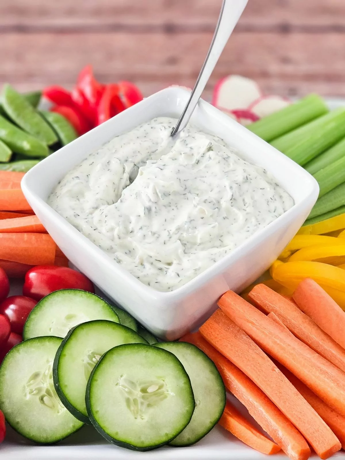 Homemade Dill Dip in small bowl with vegetables for appetizer.