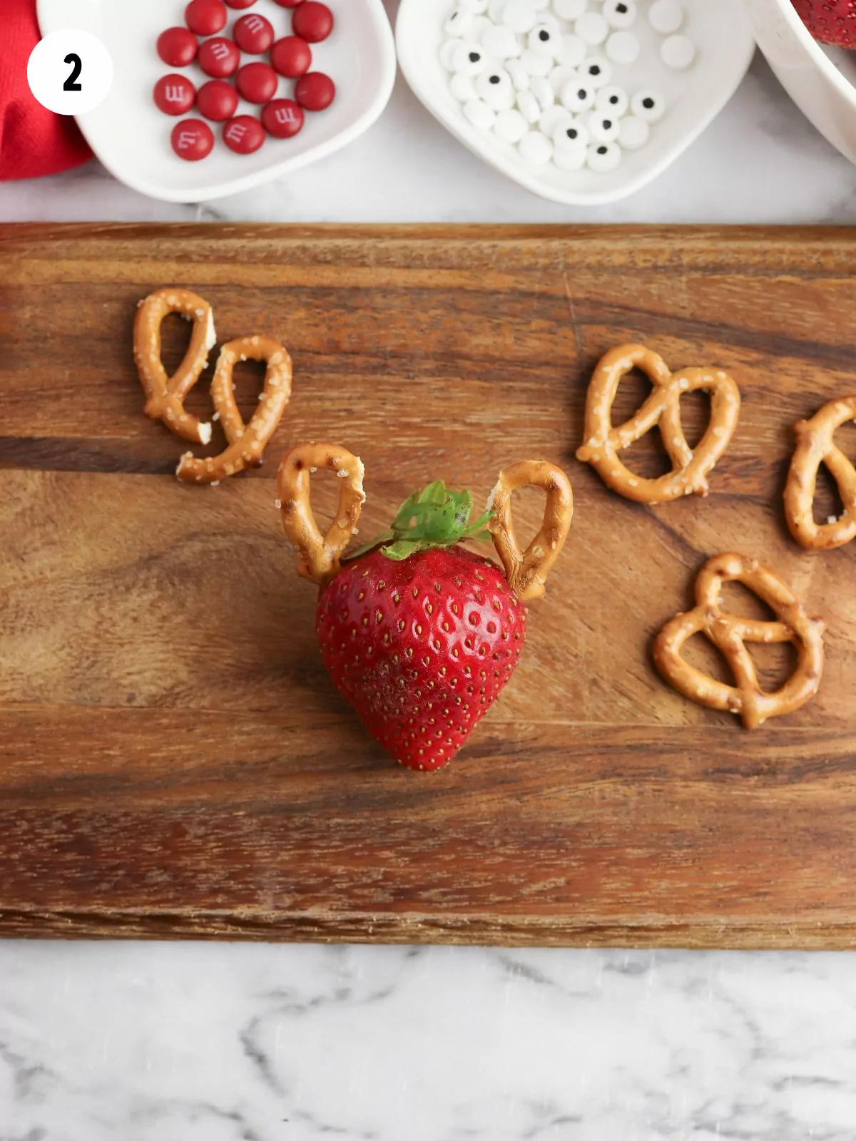 Add pretzels to strawberries.