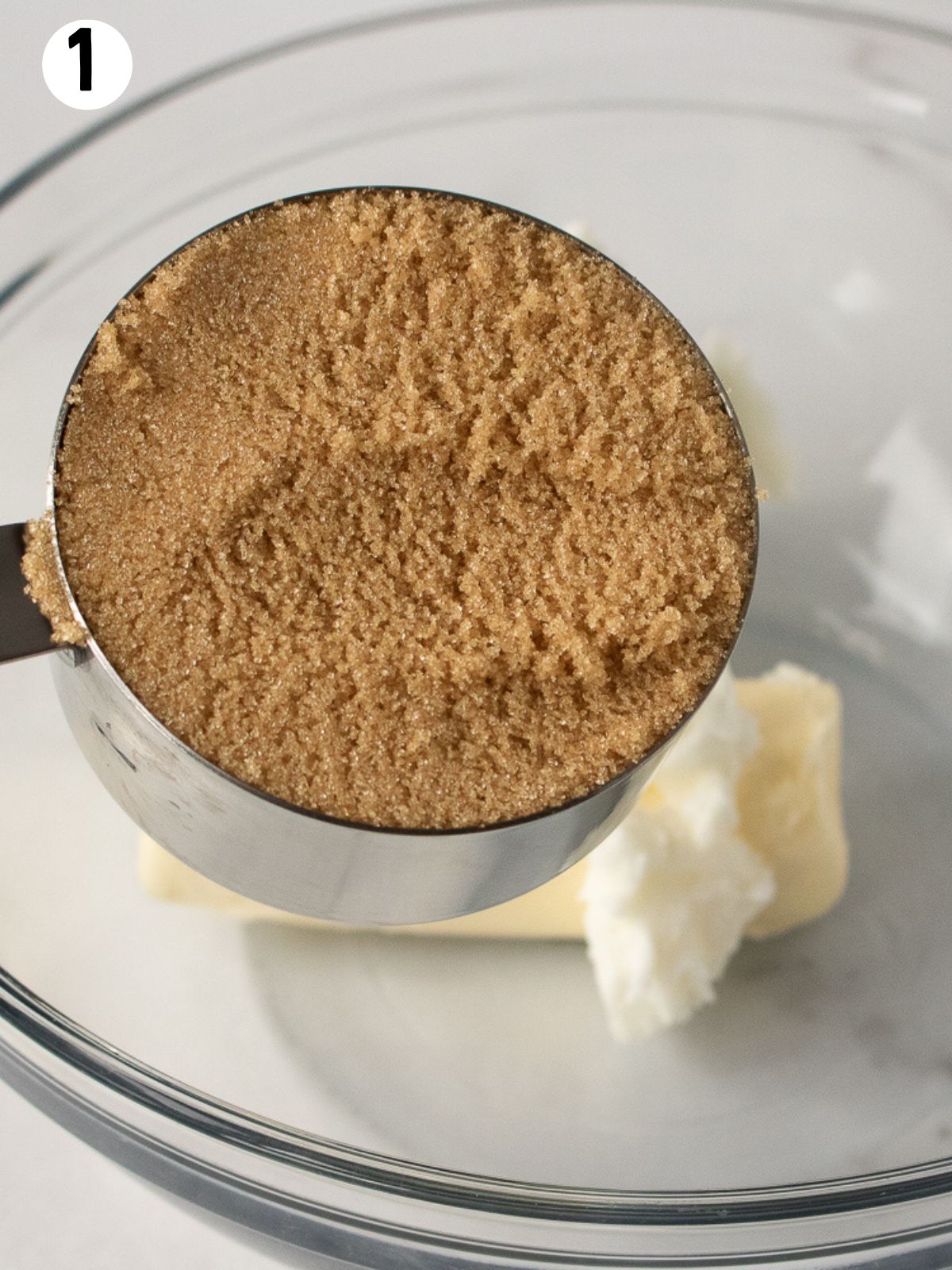 Brown sugar in measuring cup.