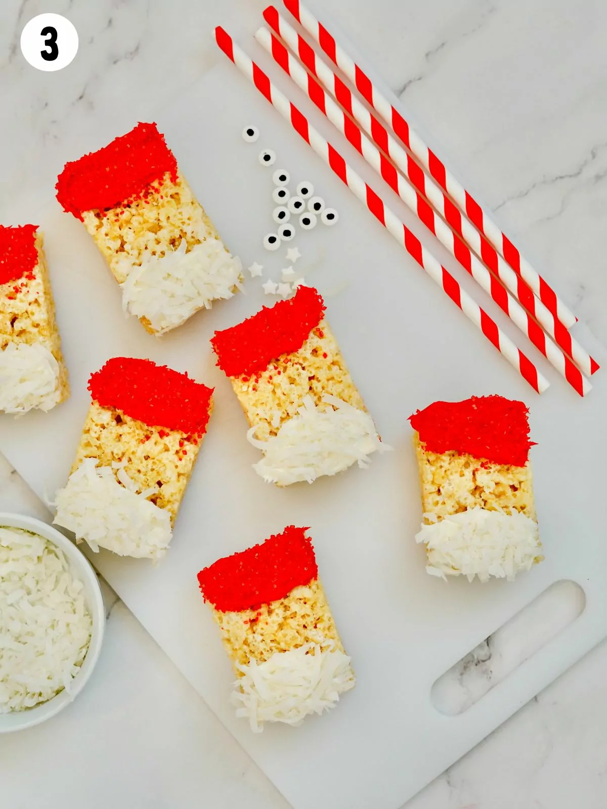 Red frosting and coconut flakes on Rice Krispy Treats.