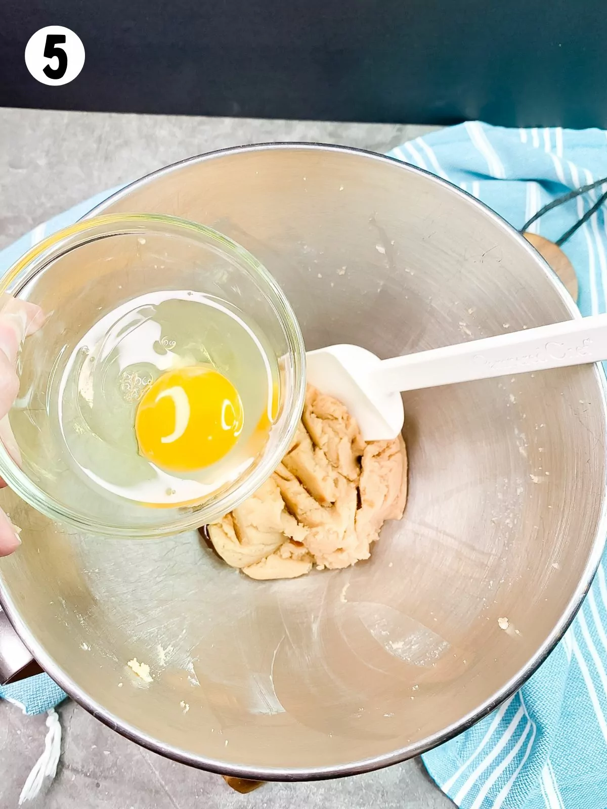 1 egg in small bowl with butter sugar mixture in large bowl with rubber spatula.