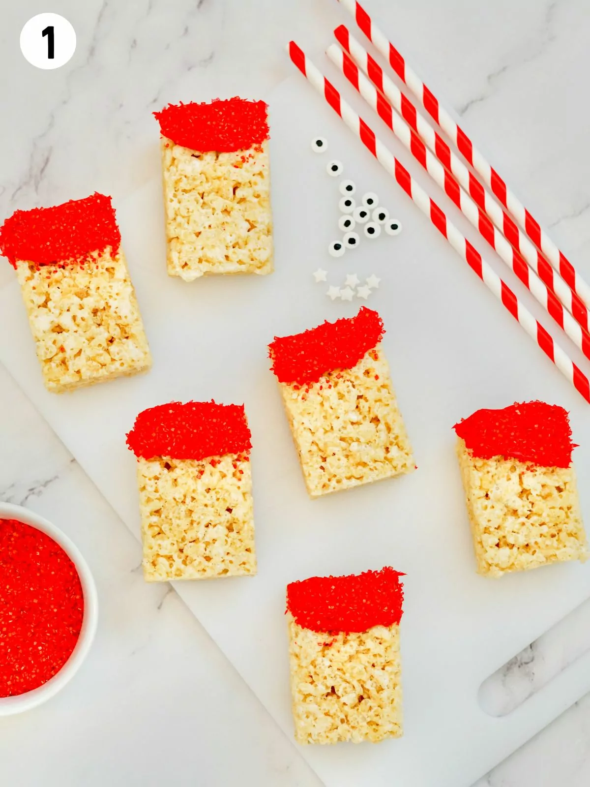 rice krispie treats with red frosting on top.