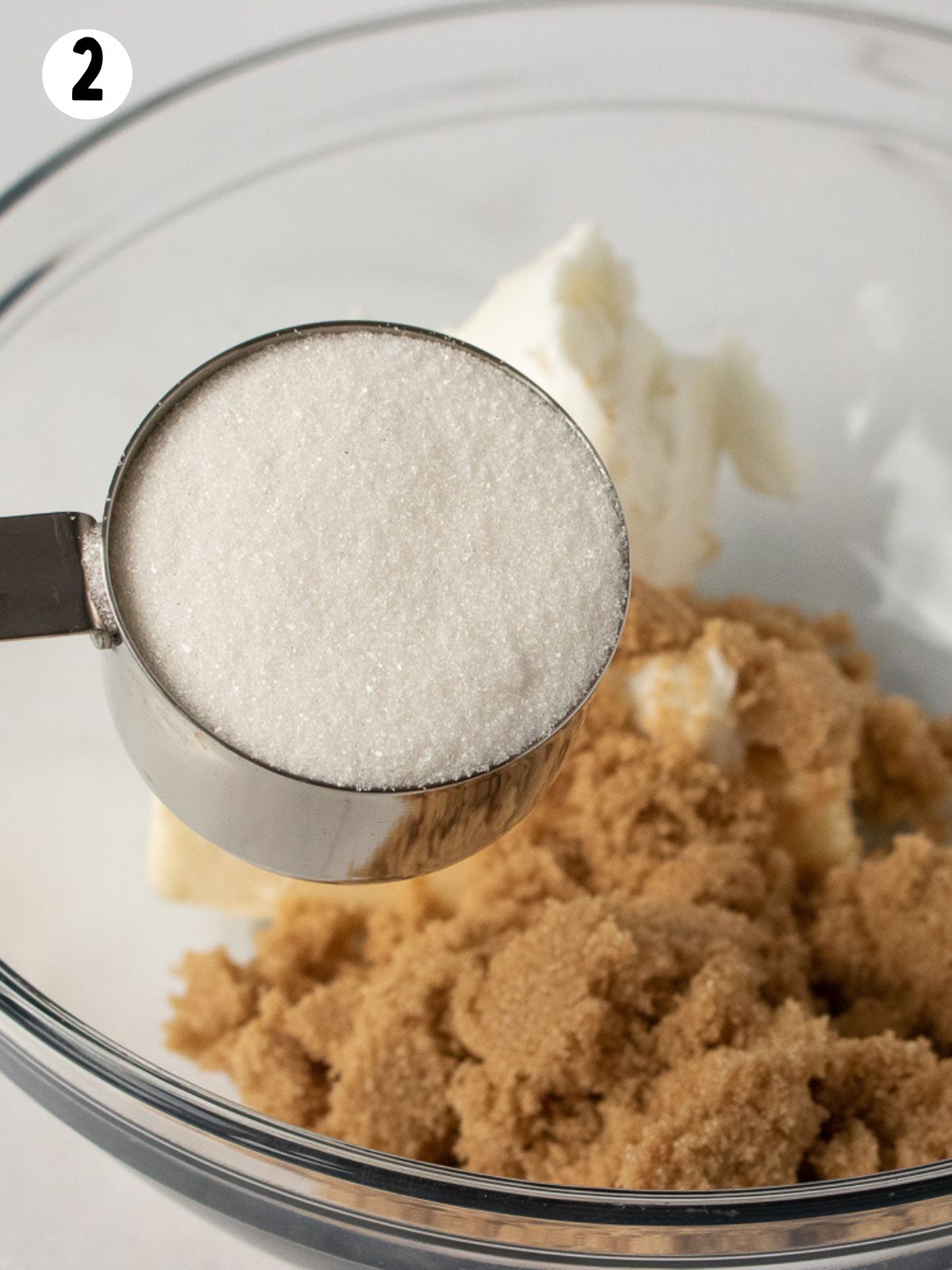 Granulated sugar in measuring cup.