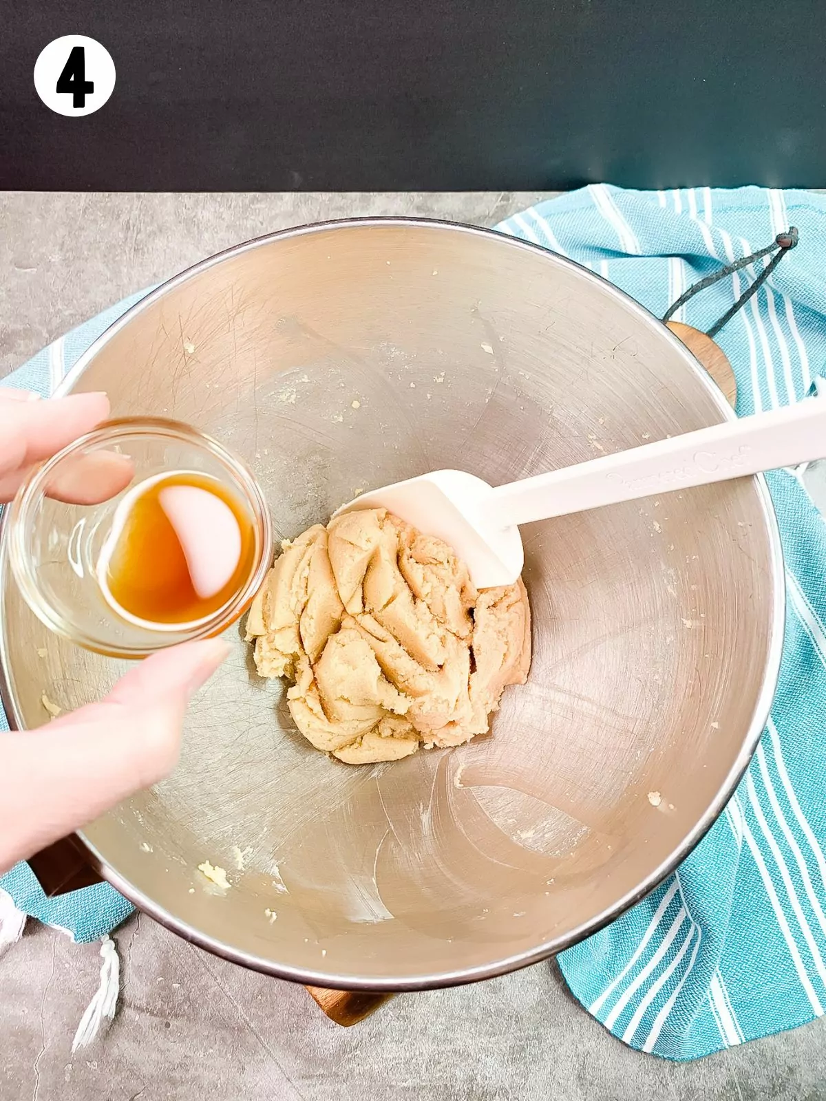 vanilla extract in small bowl over cookie dough batter.