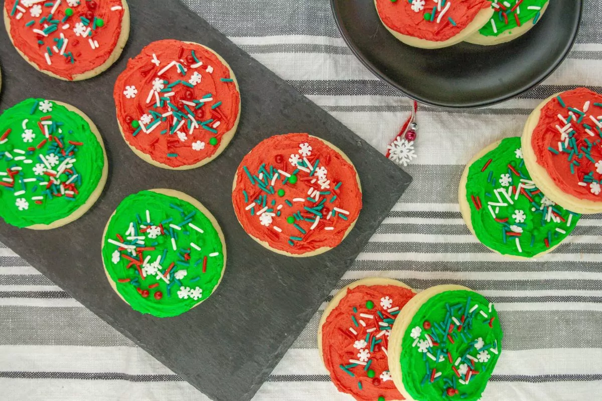 overhead view of cookies with red and green frosting topped with Christmas spinkles