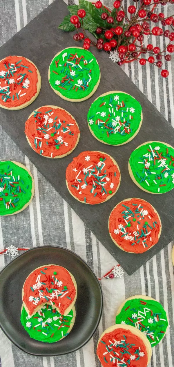 Christmas cookies with red and green frosting topped with Christmas sprinkles