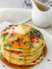 pancakes with sprinkles on white plate.