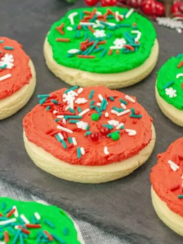 red and green frosted cookies with Christmas sprinkles.