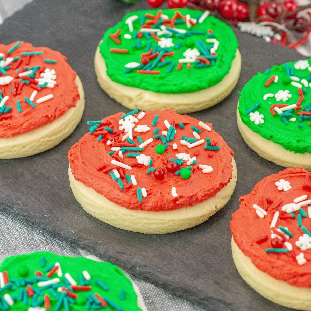 red and green frosted cookies with Christmas sprinkles.