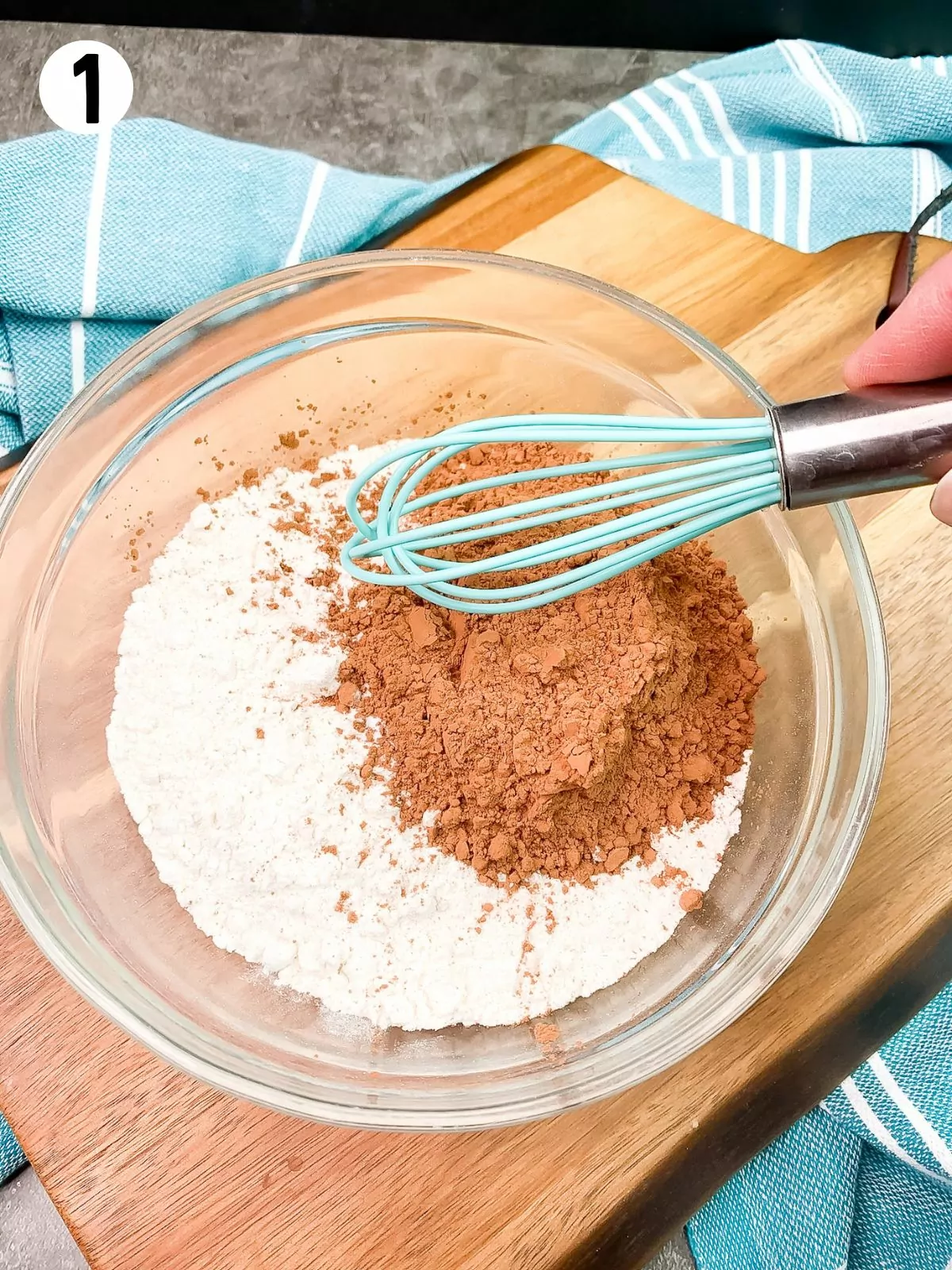 combine flour and unsweetened cocoa powder together in bowl with wire whisk.