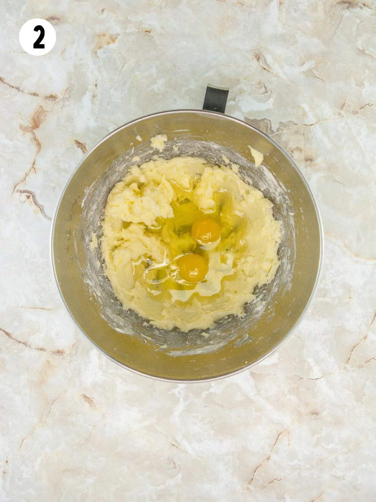 Butter, sugar and eggs in mixing bowl.