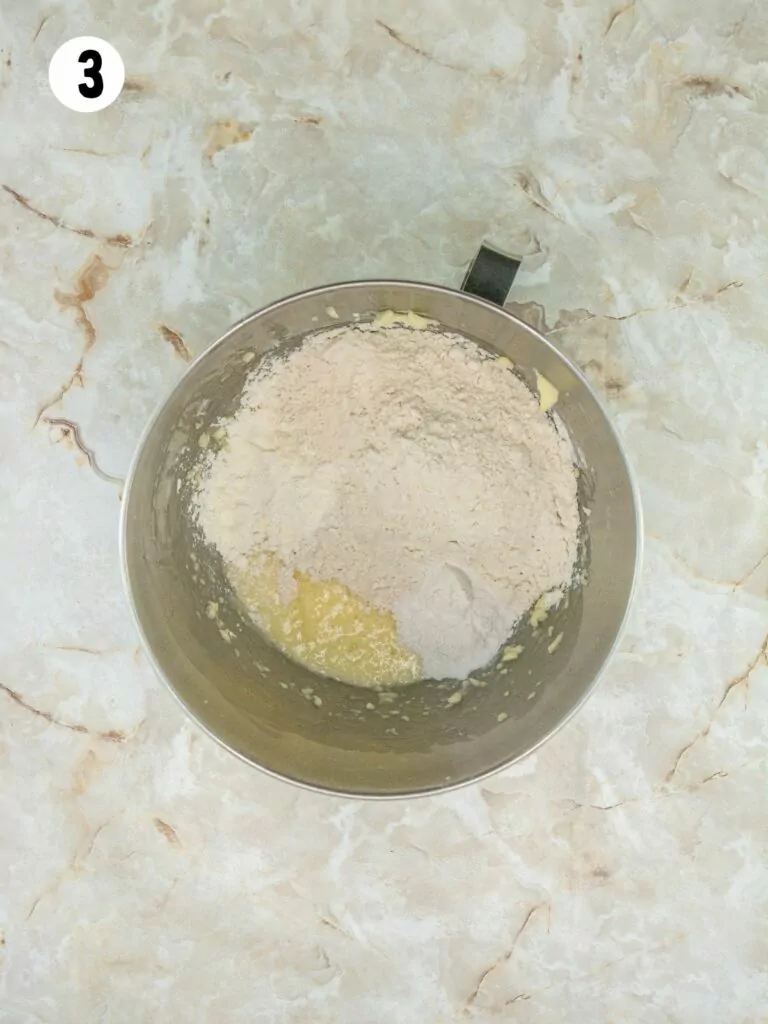 flour mixture with butter, sugar and eggs in mixing bowl.