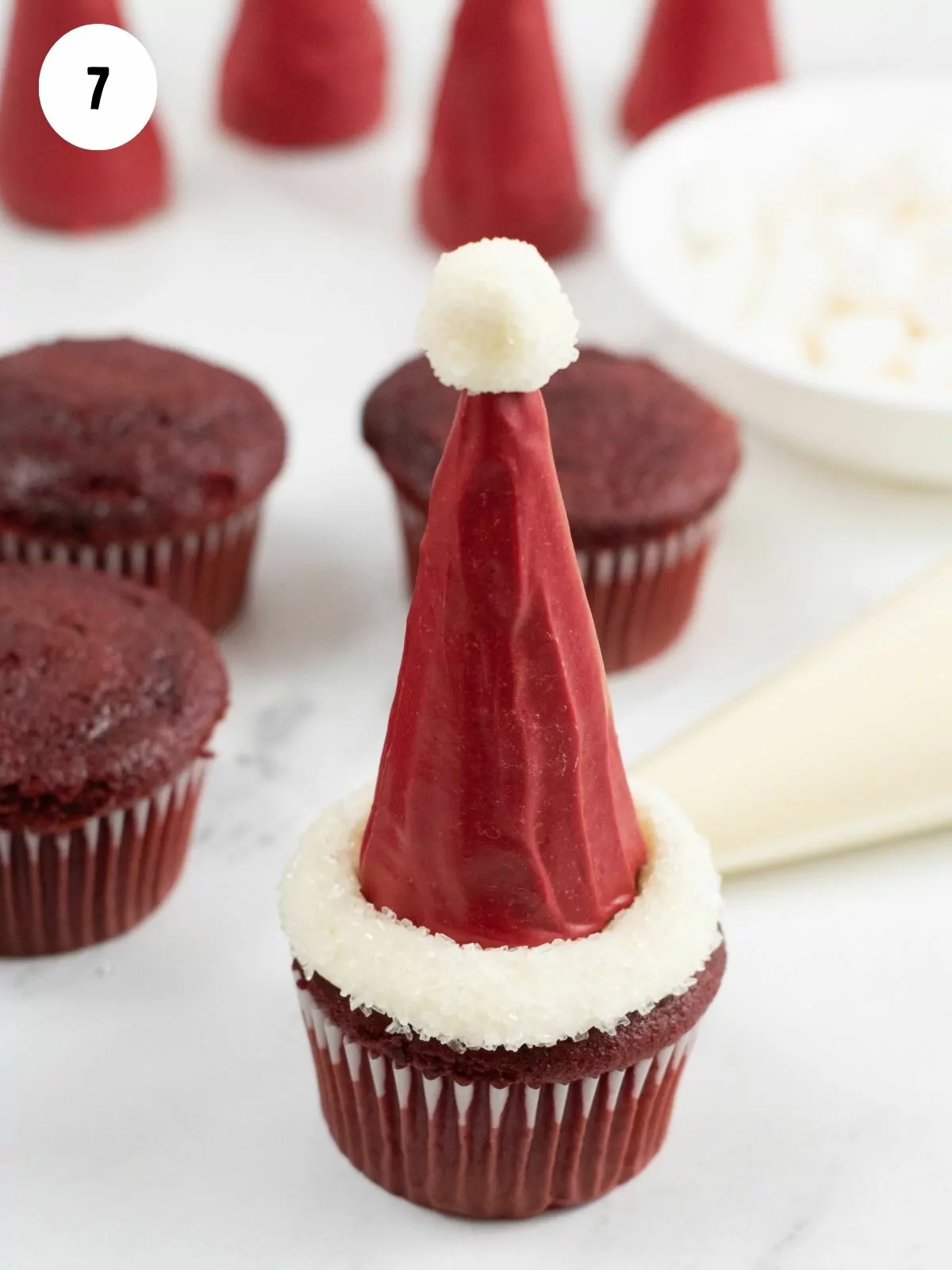 cupcake decorated with Santa hat ice cream cone.