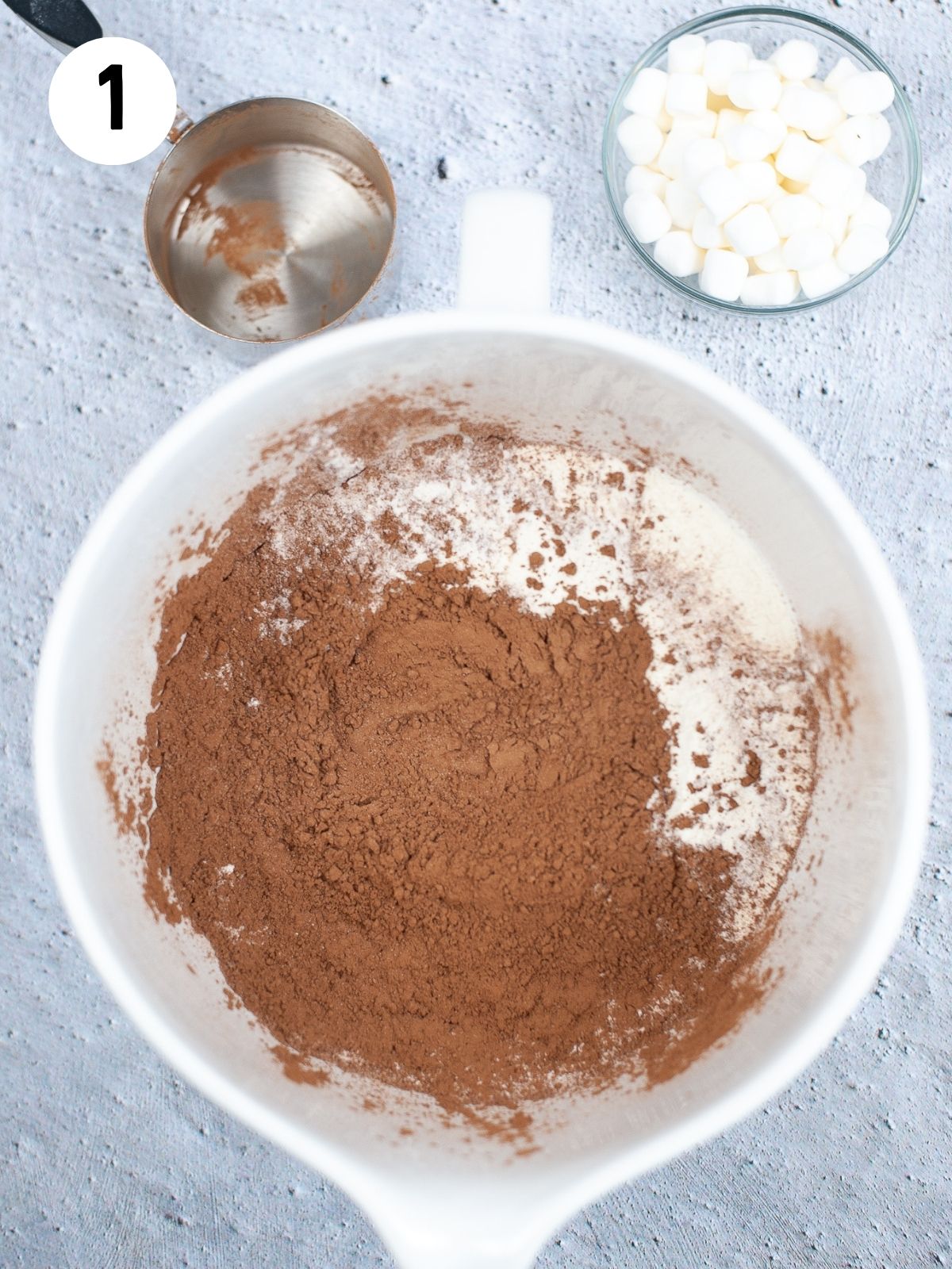 add hot cocoa ingredients together in bowl.