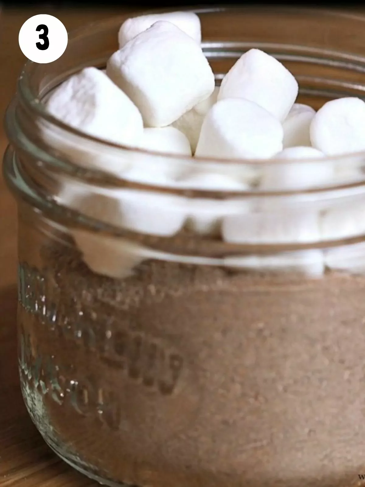add mini marshmallows to the top of mason jar hot chocolate mix.