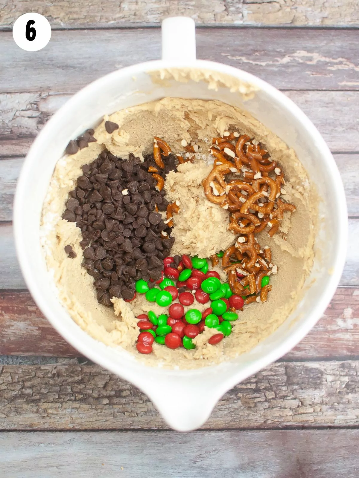 cookie dough with chocolate chips, pretzels and candy pieces for Christmas.