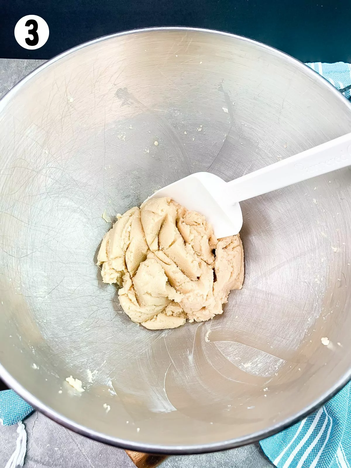 cookie dough in bowl with rubber spatula.