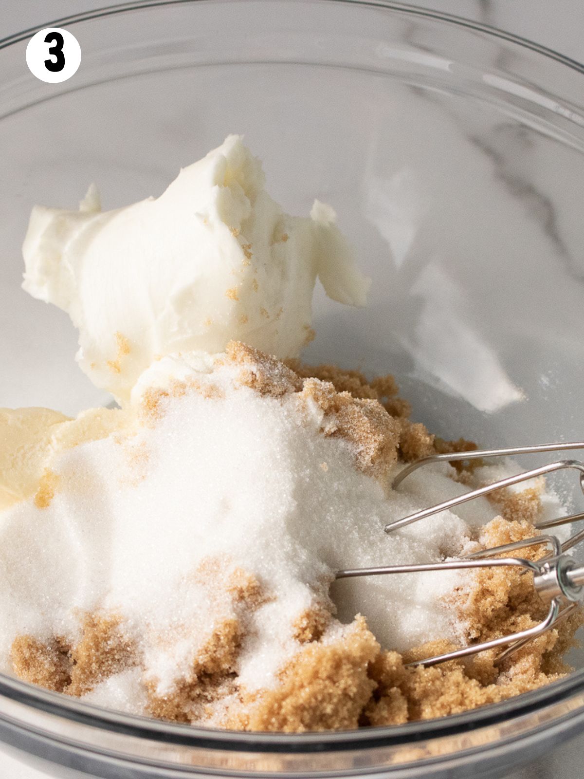 mixer with brown sugar, granulated sugar and butter in bowl.