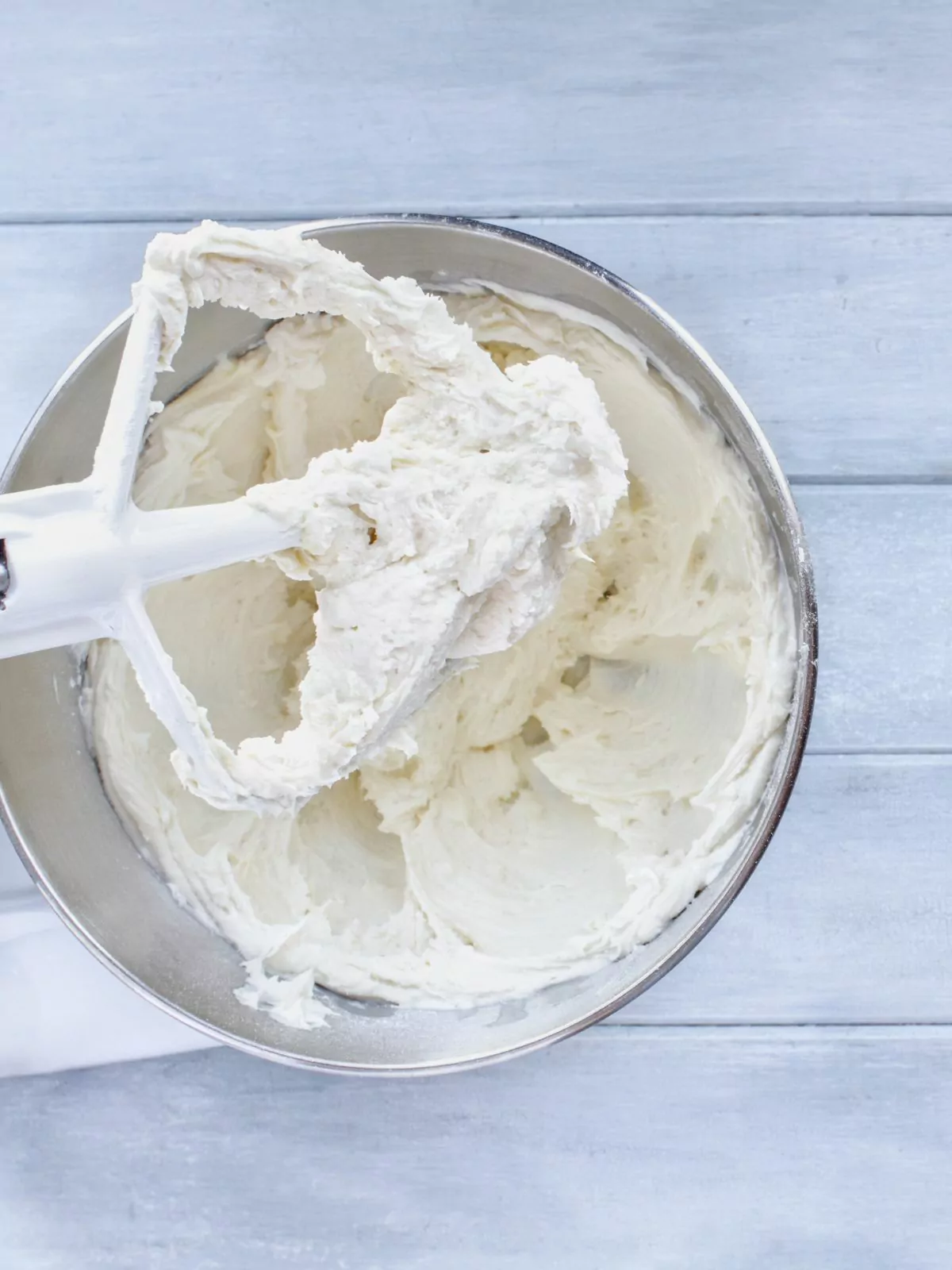 cream cheese frosting in mixing bowl with beater.