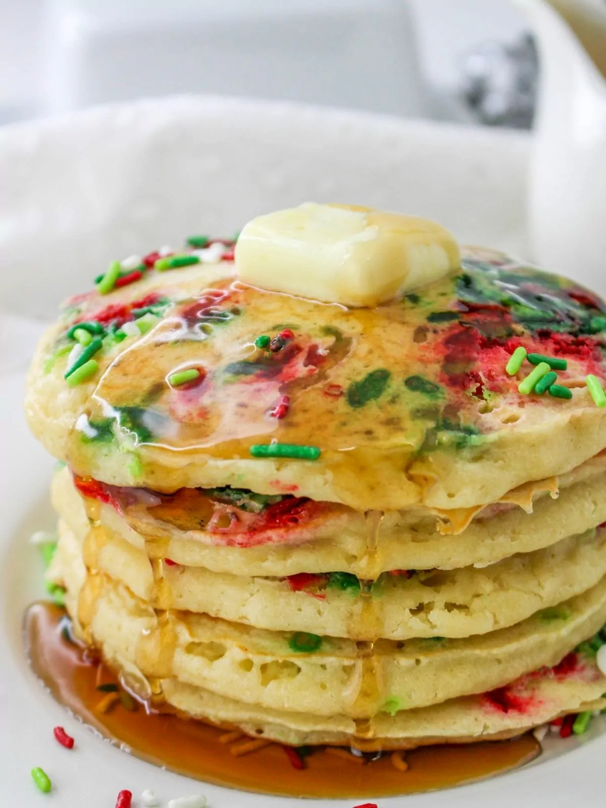 stack of Christmas pancakes with syrup and butter.