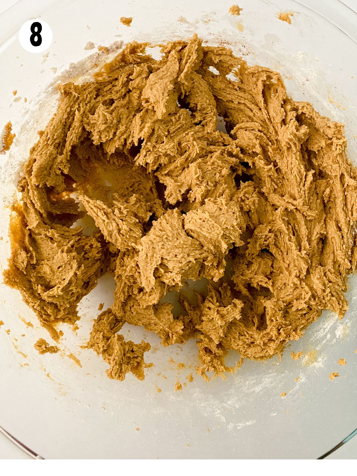 gingersnap cookie dough mixed completely in glass bowl.