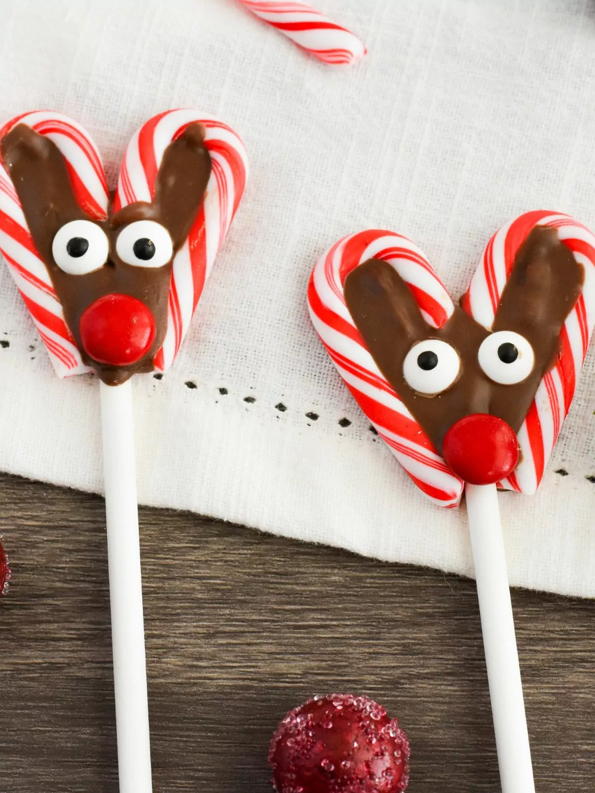 candy cane heart shaped lollipops decorated like reindeer.