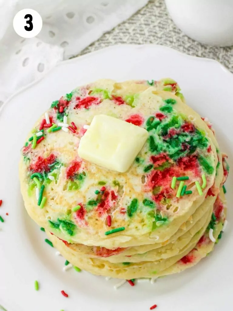 sprinkle pancakes with butter on plate.