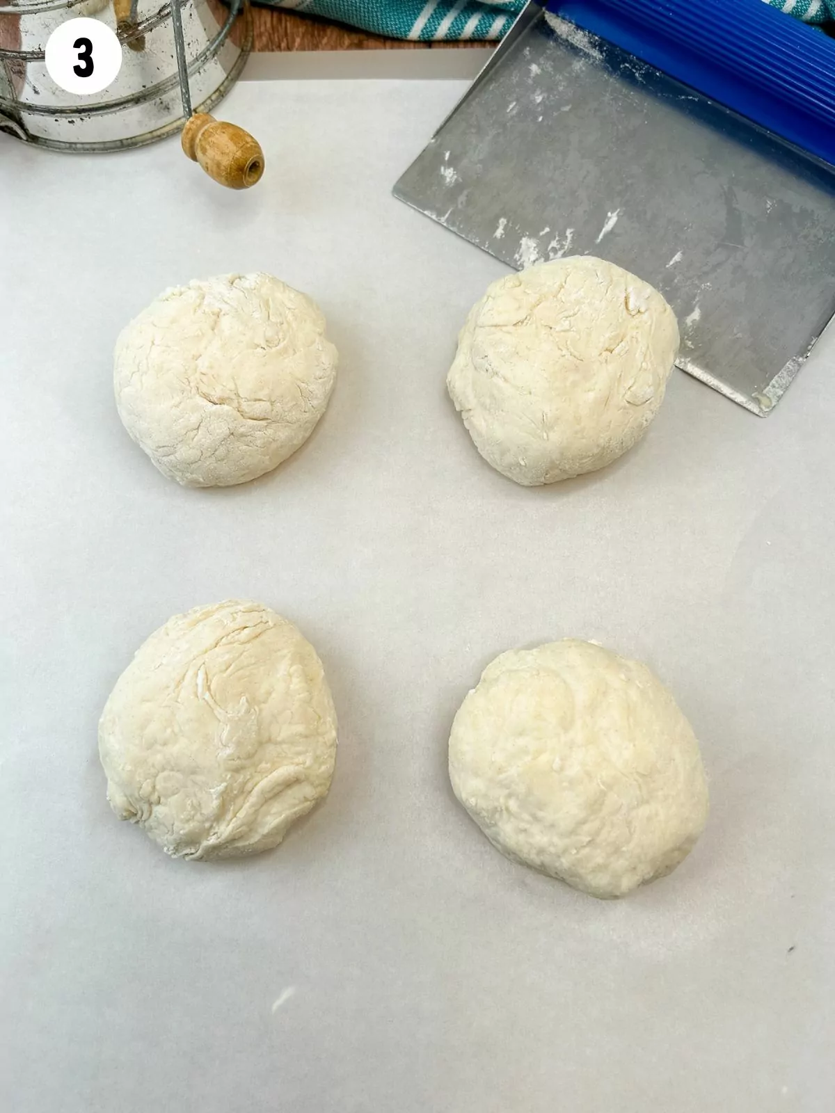 4 dough balls with dough scrapper.