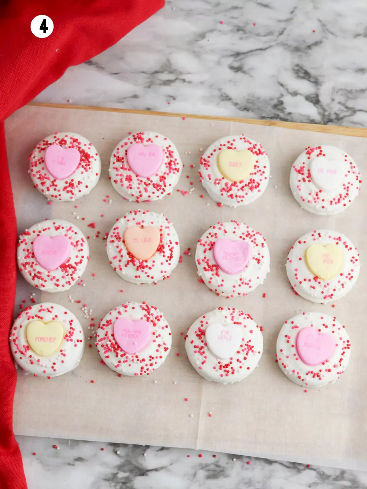 white chocolate covered Oreos with conversation heart candies.