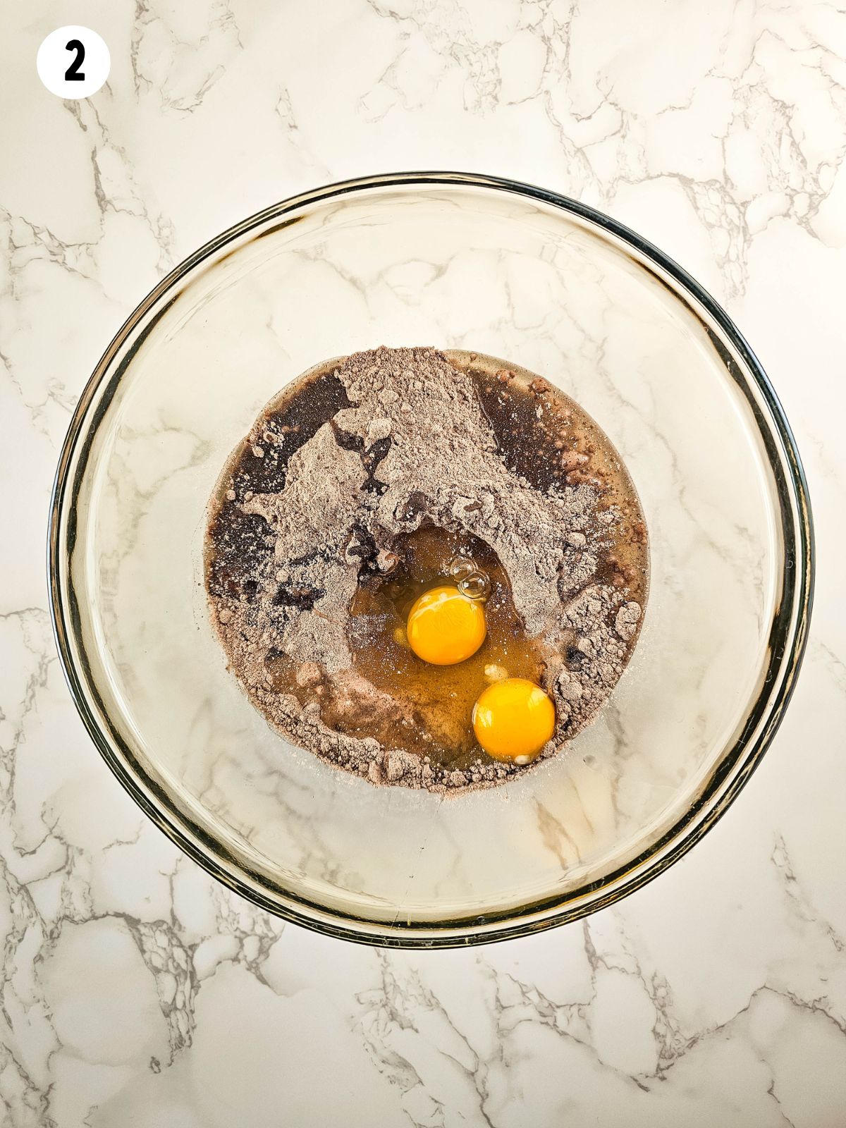cake mix in bowl with 2 raw eggs.
