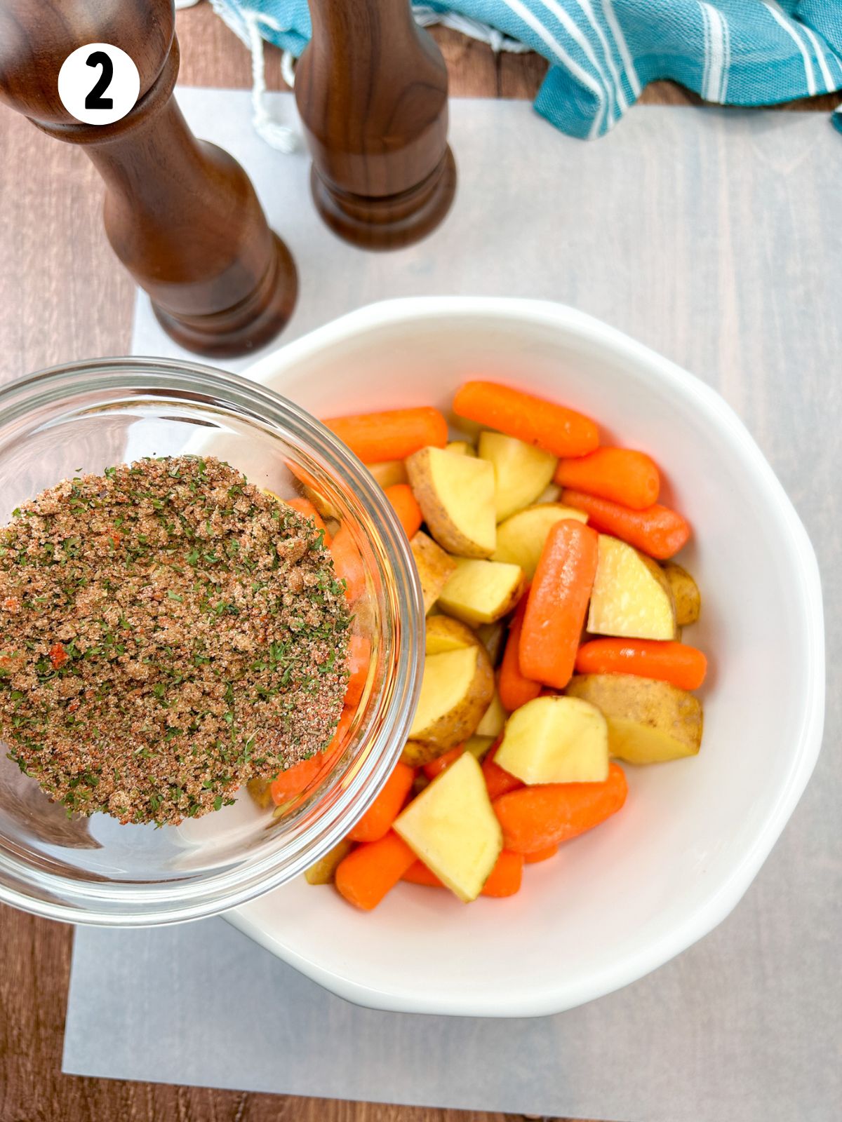 add seasoning mix to bowl of carrots and potatoes.