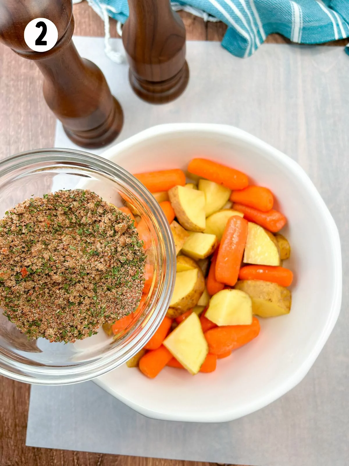 add seasoning mix to bowl of carrots and potatoes.