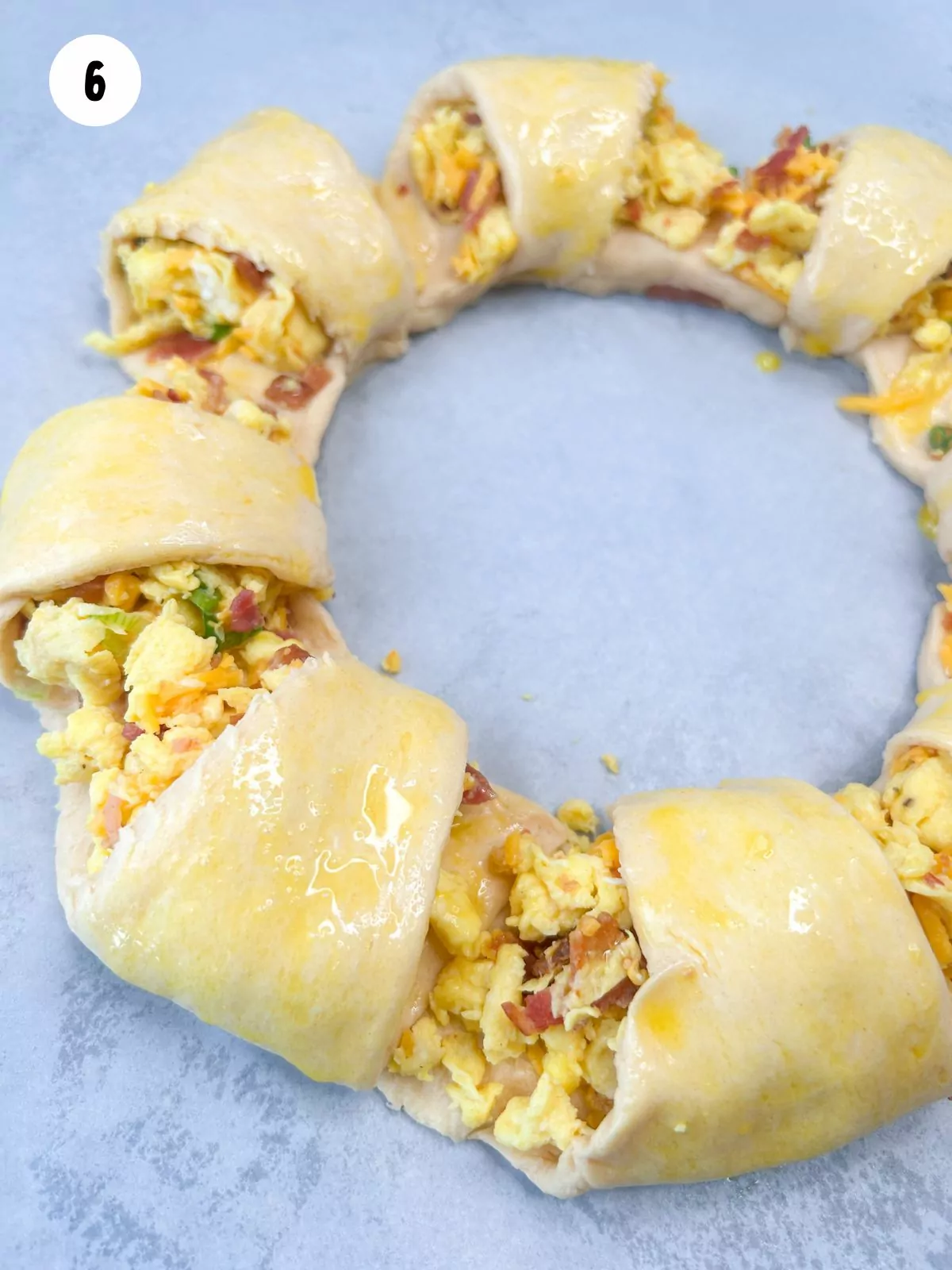 egg wash on top of unbaked crescent roll wreath.