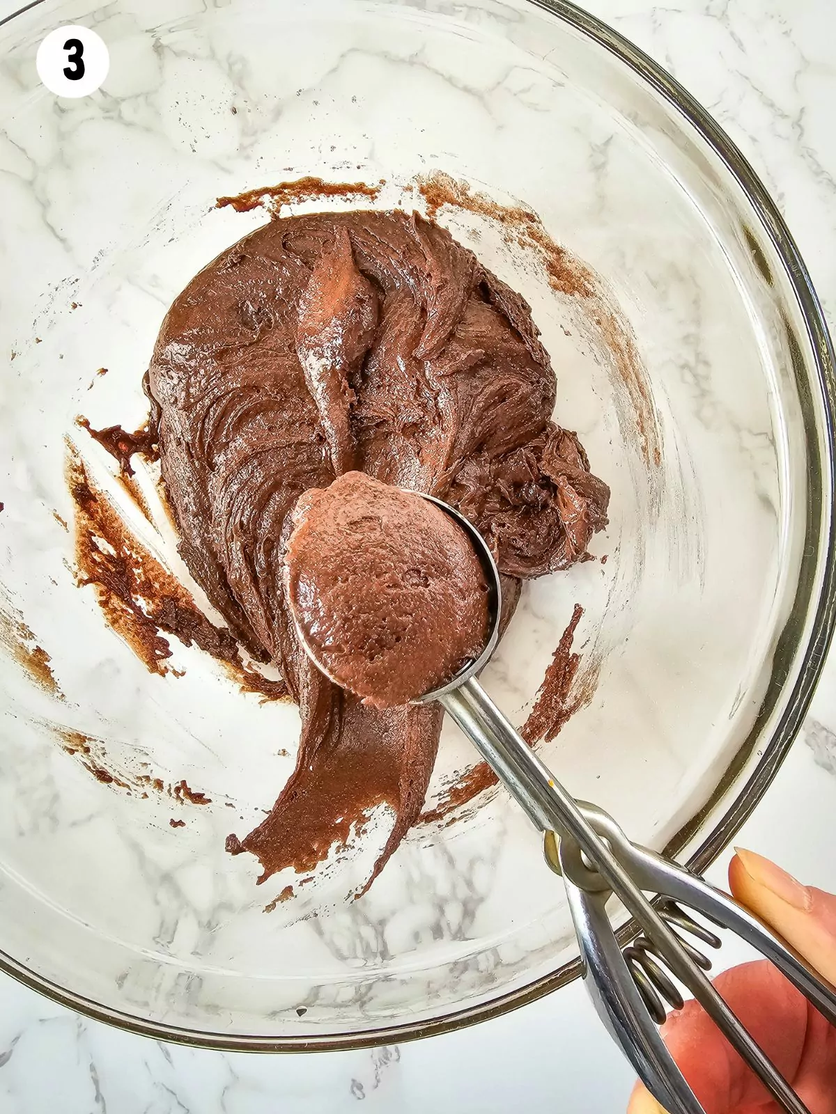 Cookie scoop with chocolate cake mix dough.