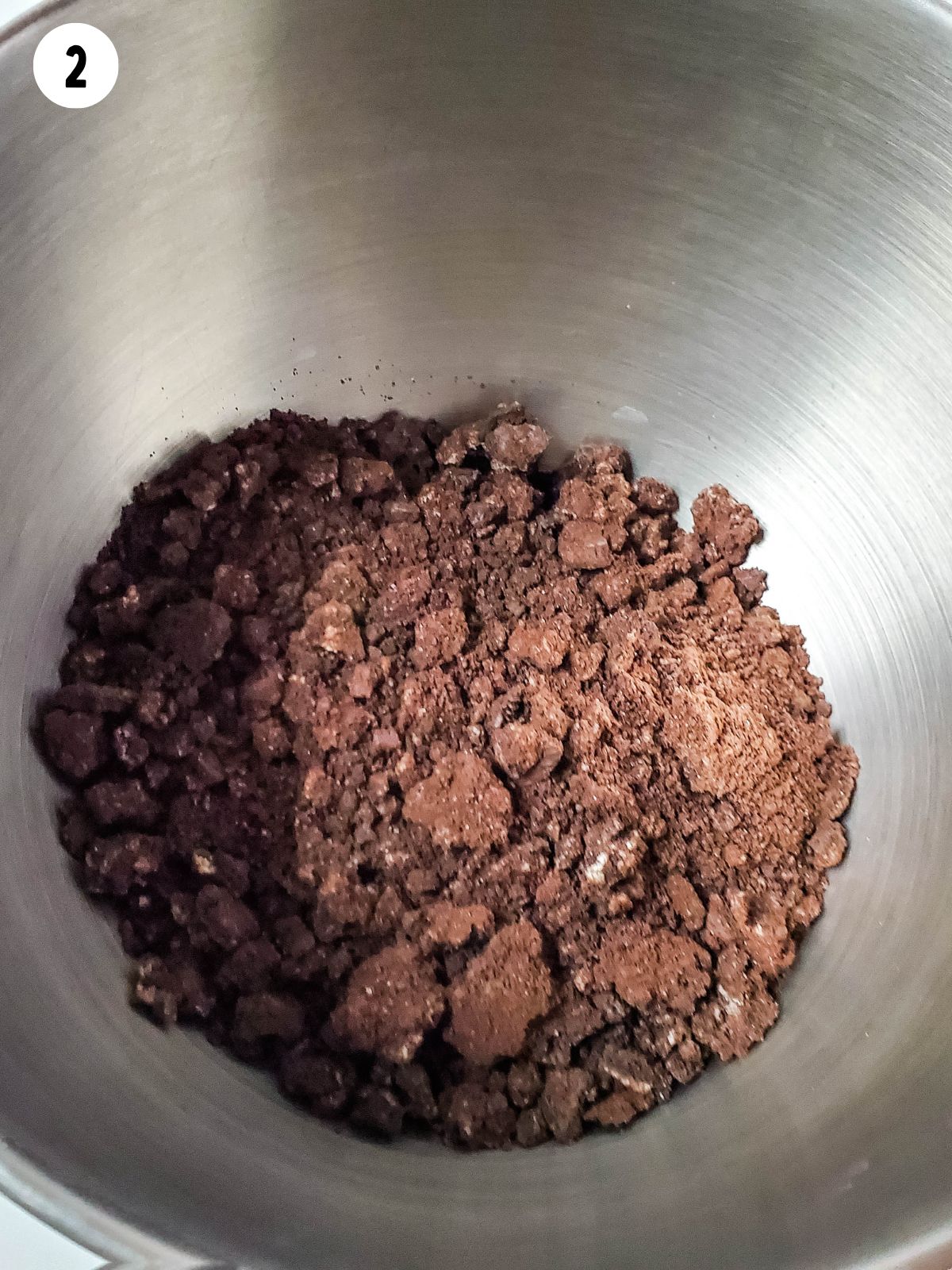 Crushed Oreo cookies in bowl.