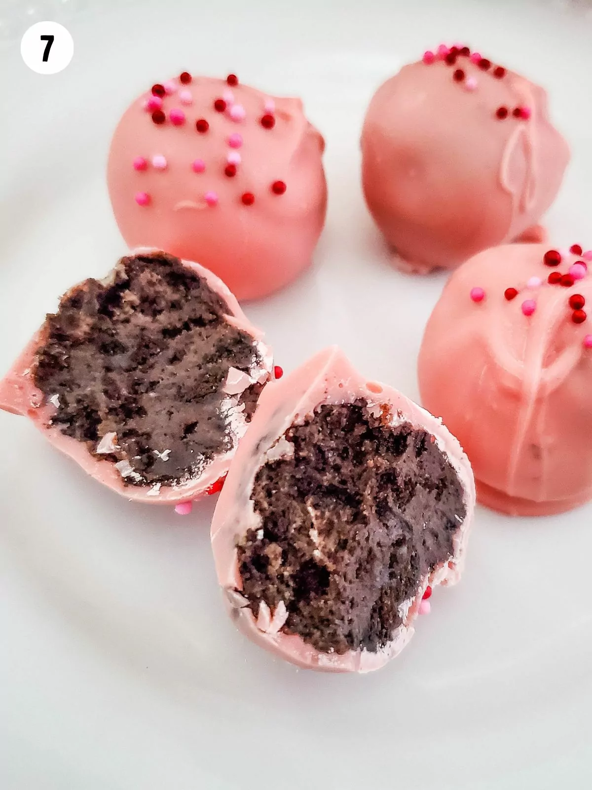 Inside view of Oreo balls dipped in pink melted chocolate.