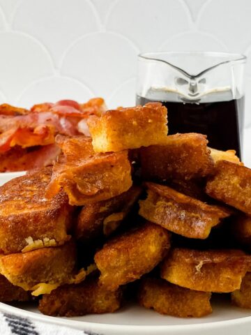 French toast served with bacon and warm syrup.