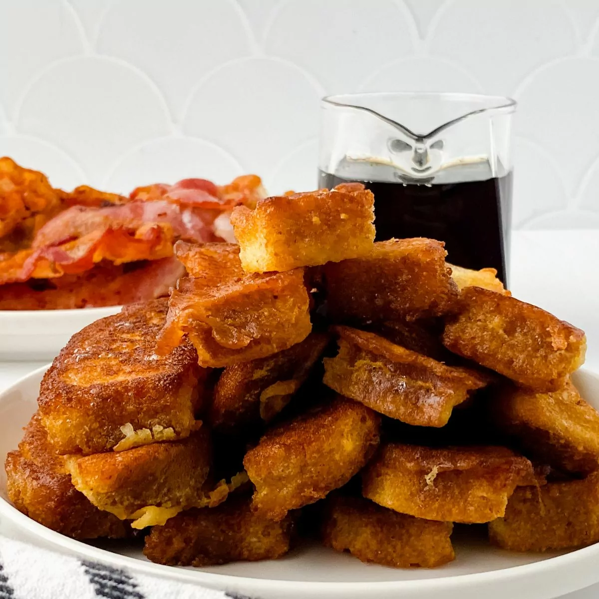 French toast served with bacon and warm syrup.