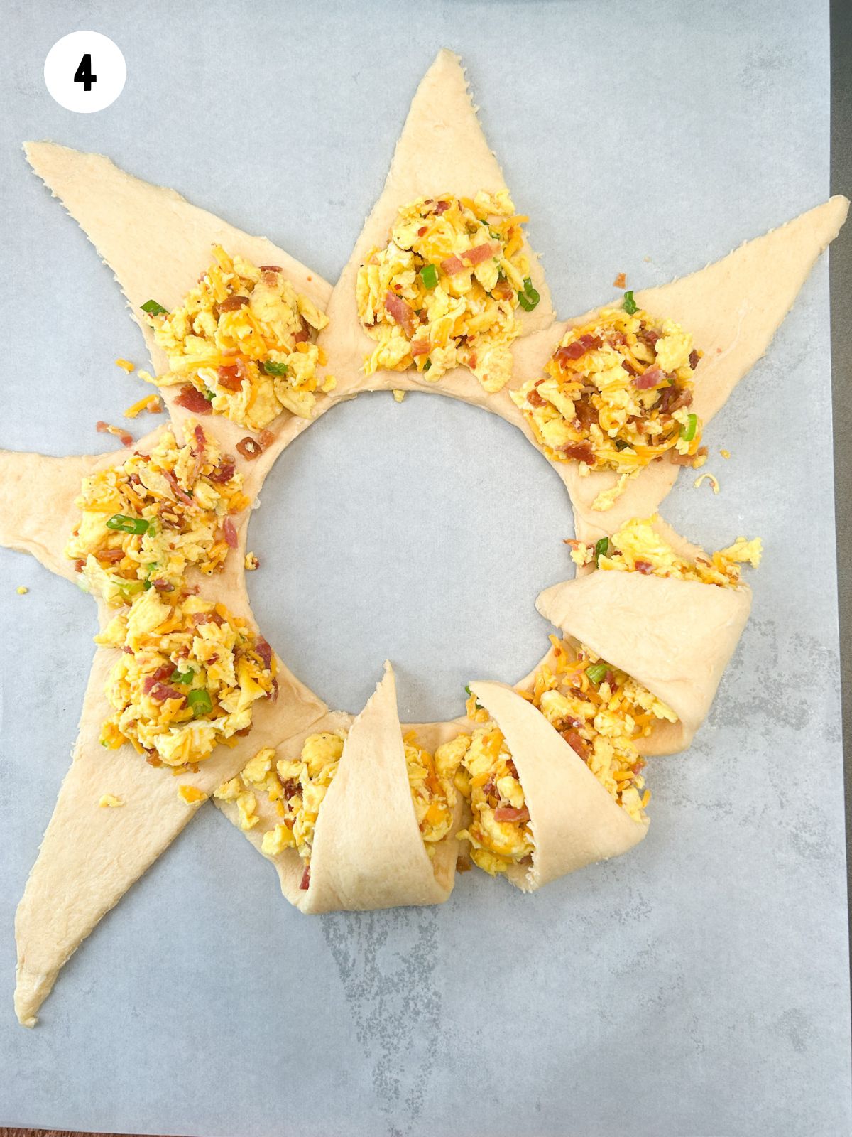 crescent rolls in a circle with scrambled eggs.