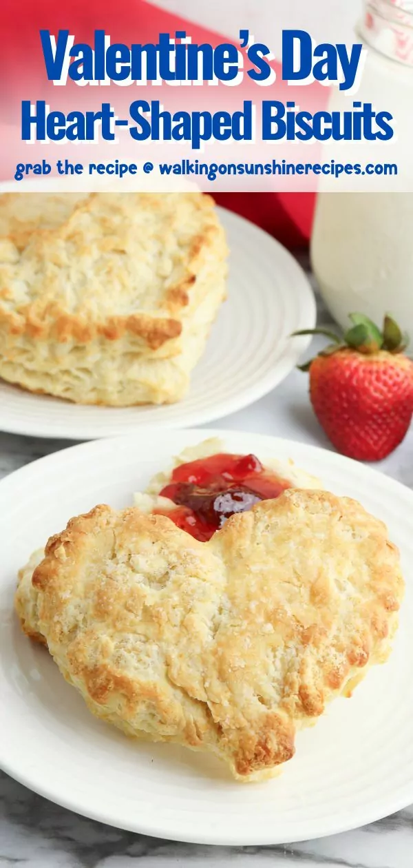 Heart shaped biscuits for Valentine's Day on white plate with fresh strawberries and jam.