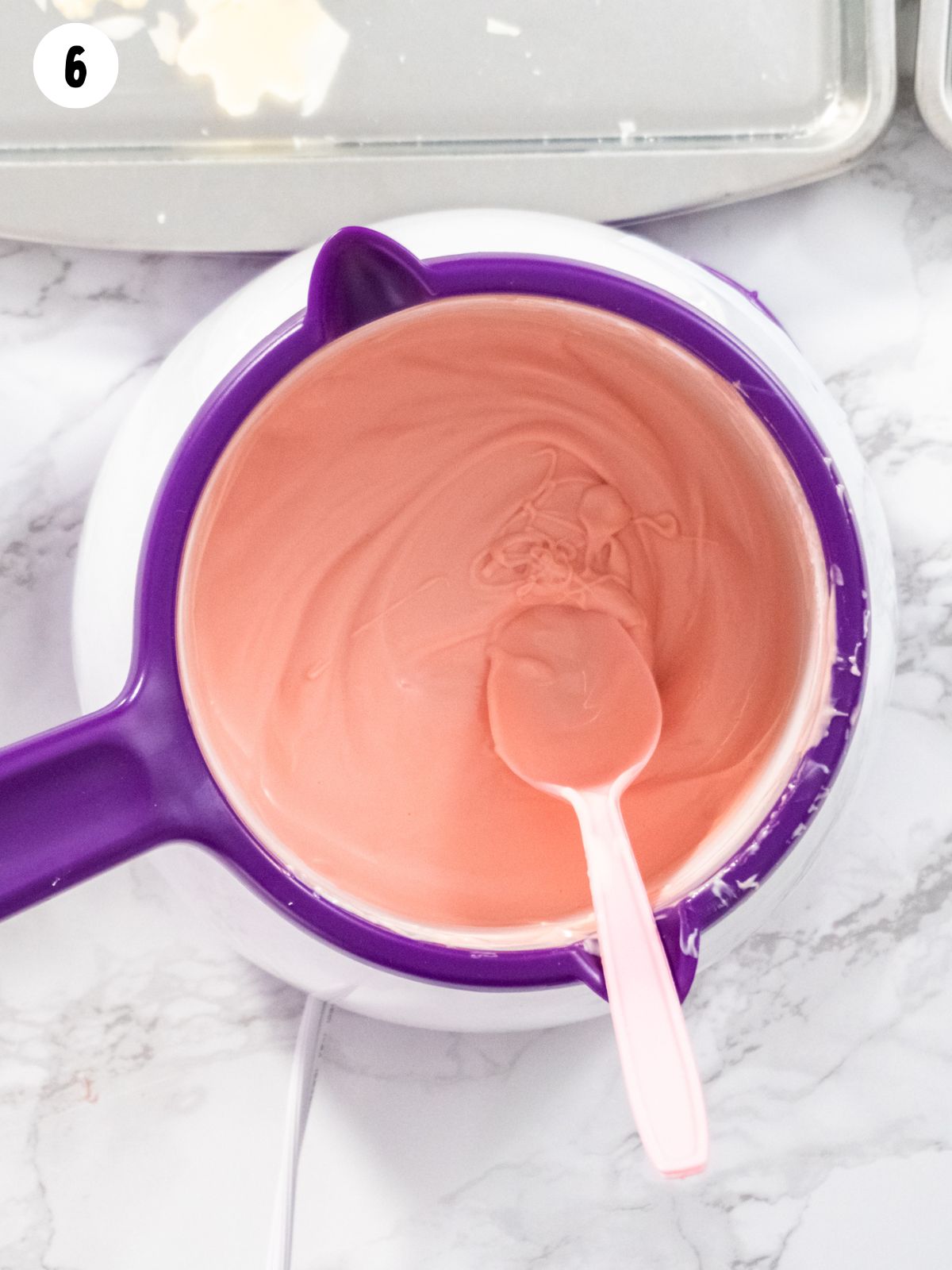 pink melted candy in white bowl.