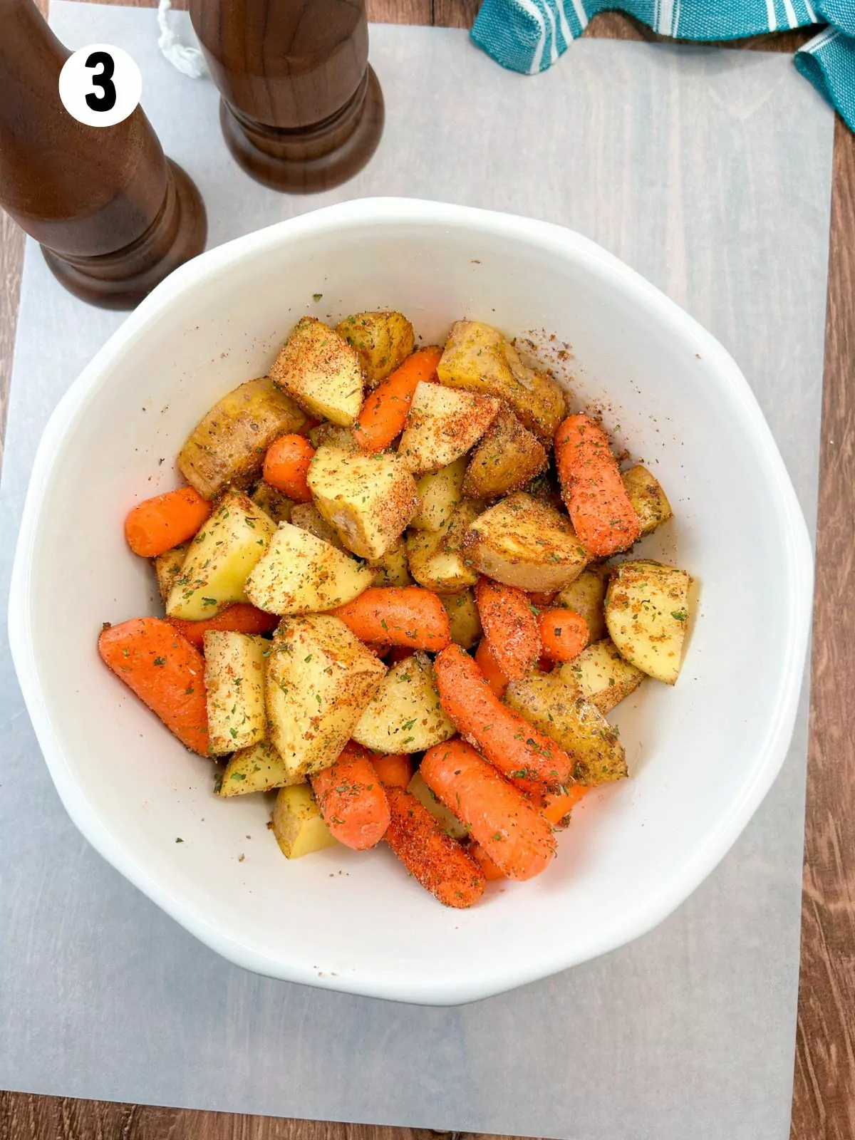 seasoned potatoes and carrots in white bowl.