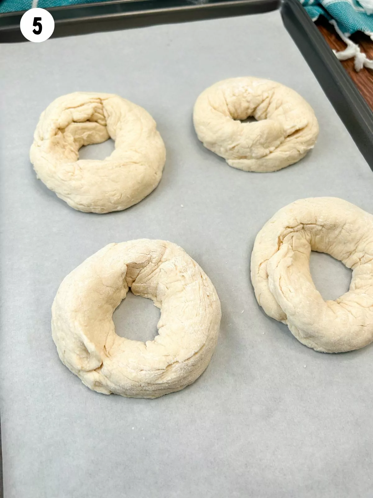 2 ingredient dough bagels on baking tray with parchment paper.