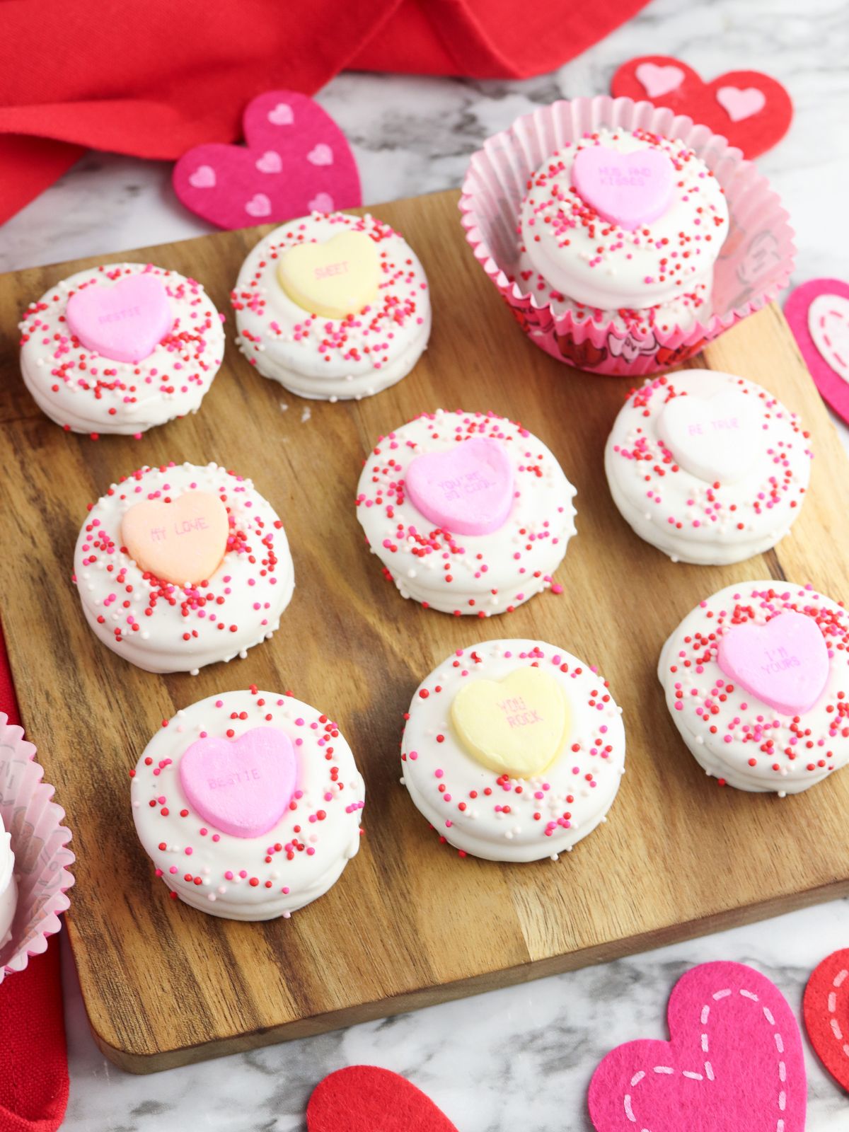 decorated Oreos with white chocolate, sprinkles and candies.