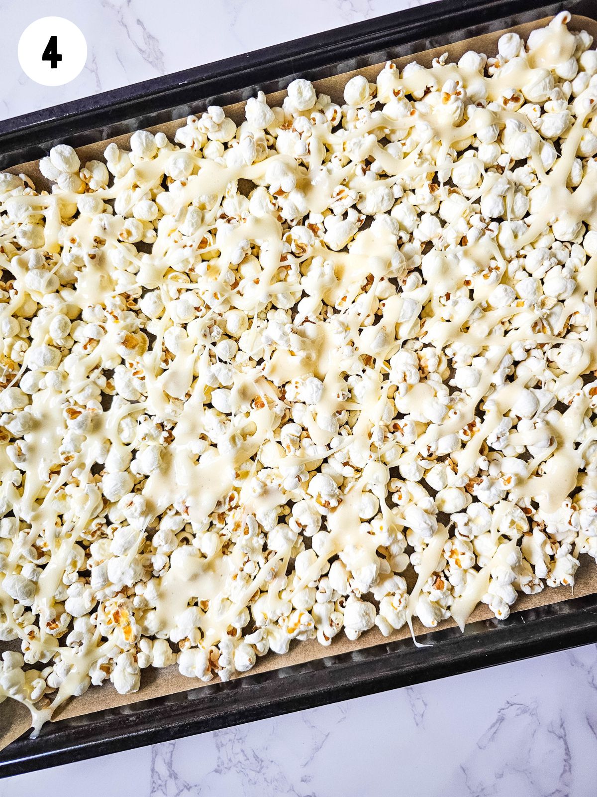 Melted marshmallows on top of popcorn.
