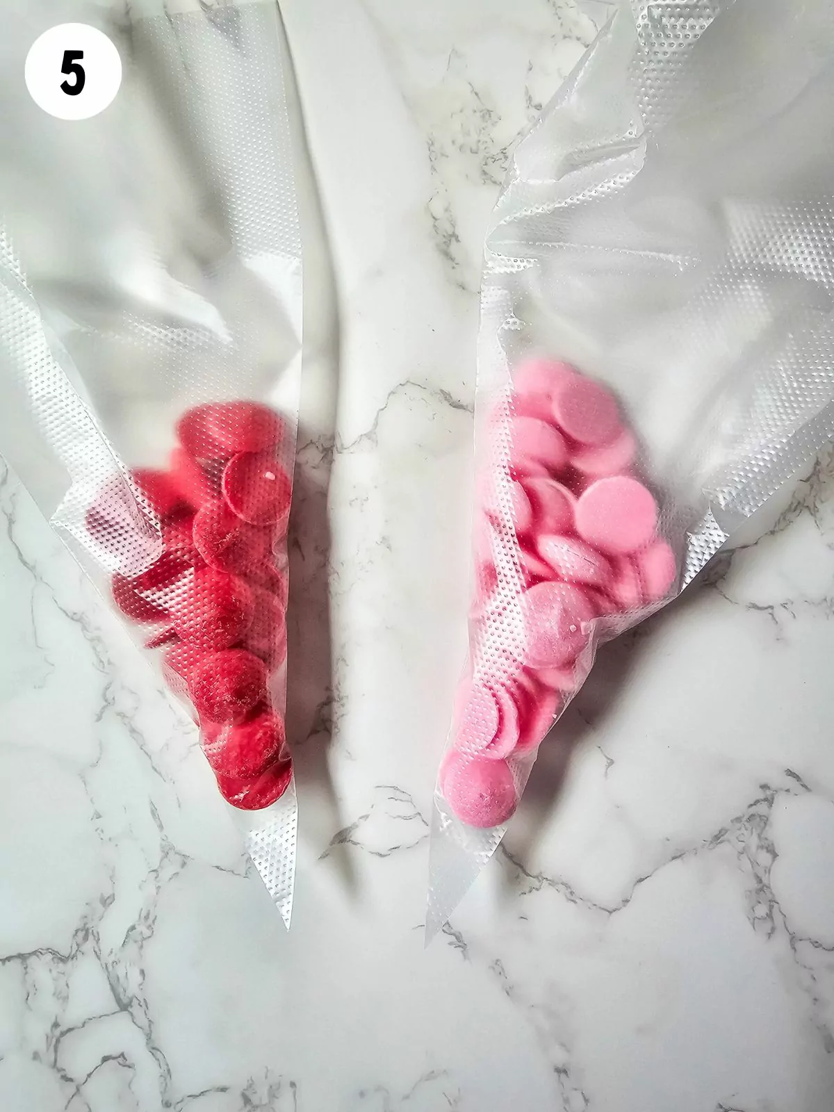 Pink and red candy melts in piping bags.