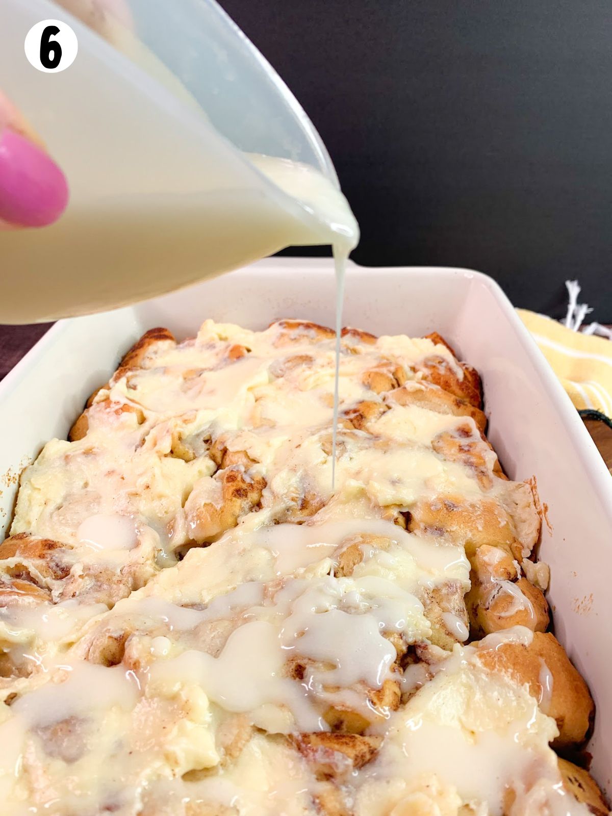 Pour icing over baked cinnamon roll casserole.