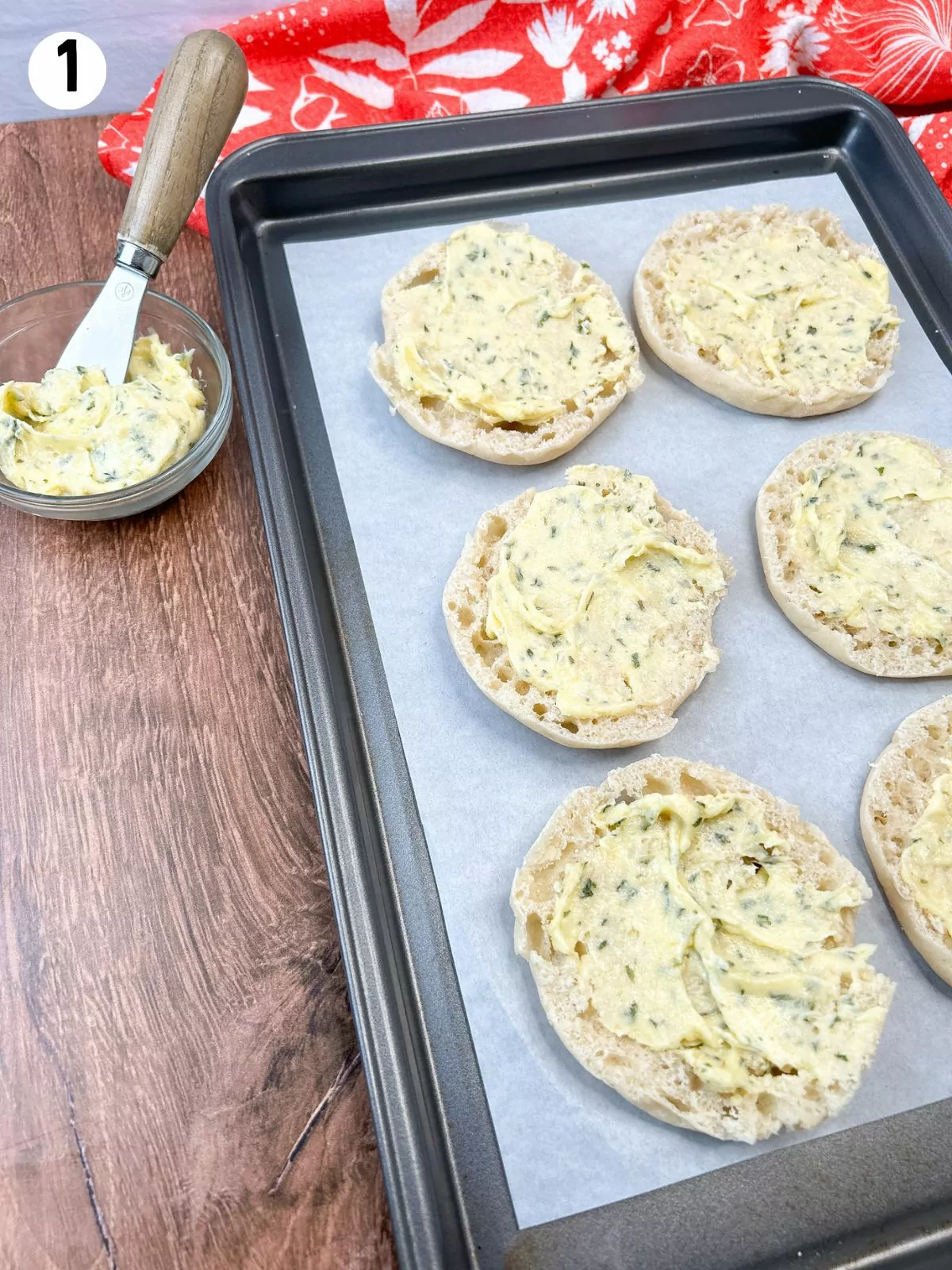 English muffins with garlic butter in small bowl.