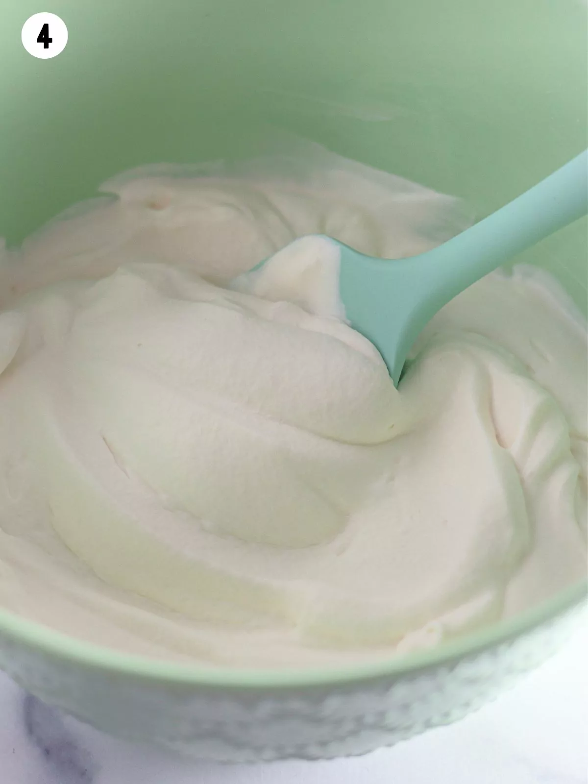 Homemade whipped cream in bowl.